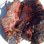 Beef ribs cooked on a Weber kettle grill.
